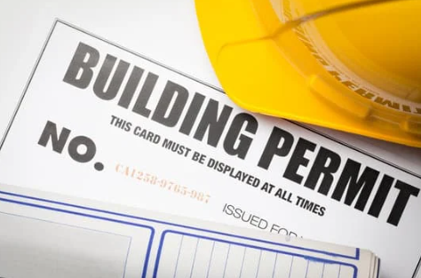 Building permit paperwork with hardhat